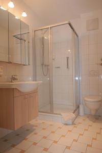 a bathroom with a shower and a sink and a toilet at Haus BEER in Bad Tölz +19 photos