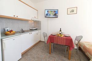 a kitchen with a table with a red table cloth at Summer Dream in Vlachata