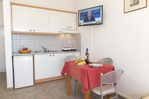 a kitchen with a table with a red table cloth on it at Summer Dream in Vlachata