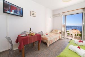a living room with a table and a room with a balcony at Summer Dream in Vlachata