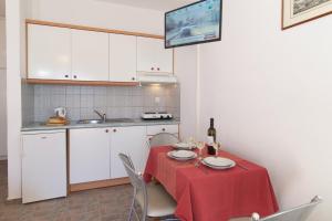 a kitchen with a table with a red table cloth at Summer Dream in Vlachata