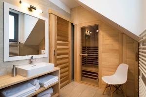 a bathroom with a sink and a mirror at Apartments Sivka - Private Sauna in Cerklje na Gorenjskem +36 photos