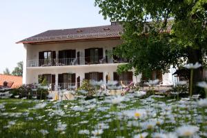 a house with a field of flowers in front of it at Haus BEER in Bad Tölz