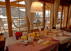 a table with a plate of fruit on a table with a view at BnB Les Sapins Bleus in Verbier