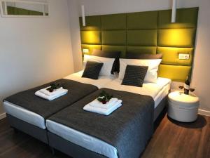 a bedroom with two beds with towels on them at Premium Apartment - Chopin AirPort in Warsaw