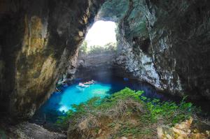 a cave with a pool of blue water in it at Summer Dream in Vlachata