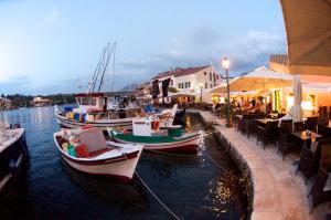 a group of boats docked in the water at a restaurant at Summer Dream in Vlachata