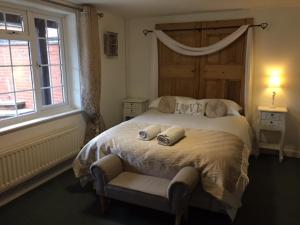 a bedroom with a large bed with two pillows on it at Magna in Shilton