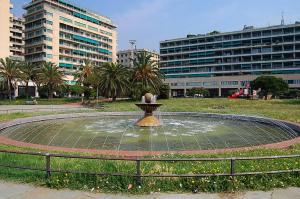 a fountain in the middle of a park with buildings at Elegante Monolocale Genova in Genoa