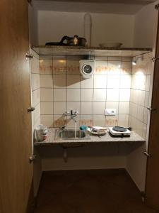 a small kitchen with a sink and a counter at Can Berge in Figueres
