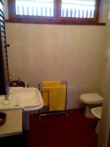 a bathroom with a sink and a toilet and a window at Luxury Apartment with View in Bardonecchia