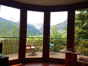 a screened in porch with a view of mountains at Luxury Apartment with View in Bardonecchia