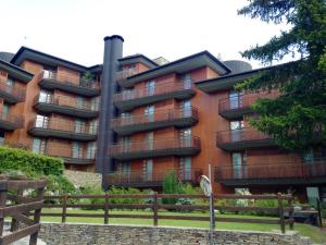 a large apartment building with a sign in front of it at Luxury Apartment with View in Bardonecchia