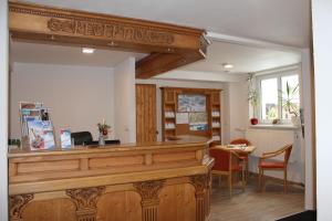 a synagogue with a wooden counter with a sign that reads keepchoes at Pension Tyrol in Maria Alm am Steinernen Meer