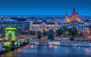 a city skyline with a bridge over a river at Parliament Apartment in Budapest