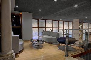 a living room with a couch and a chair at Silken Ramblas in Barcelona