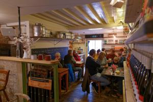a group of people sitting at tables in a restaurant at de Zeeuwse Hemel in Zierikzee