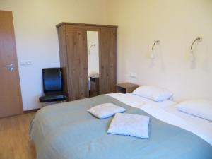 a bedroom with two beds with towels on them at Guesthouse Vellir in Vík