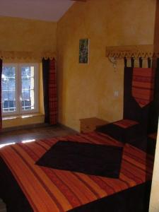 a bedroom with a large bed and a window at Le Calmadou in Formiguères