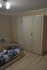 a bedroom with a bed and a large closet at Сосновий Двір in Kosiv