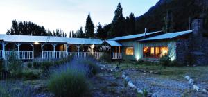 a house with a garden in front of it at Las Pitras Lodge in Epuyén