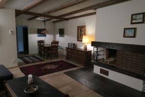 a living room with a fireplace and a dining room at Apartment Roccabella in Davos