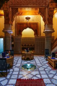 a lobby of a building with a large tile floor at Riad Al Fassia Palace in Fez