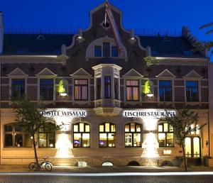 a building with a bike parked in front of it at Restaurant & Hotel Wismar in Wismar