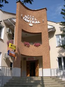 a hotel central building with stairs in front of it at Central Hotel in Soroca
