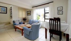 a living room with a table and a couch at Tesorino Bed and Breakfast in Durban