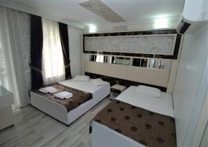 Postel nebo postele na pokoji v ubytování Behram Hotel