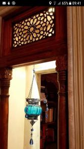 a blue light hanging from a wall in a room at Maison d'Hôtes Dar Ennassim in La Marsa