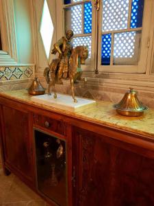 a statue of a man riding a horse on a counter at Maison d'Hôtes Dar Ennassim in La Marsa