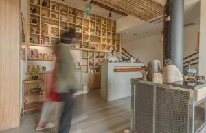 a person walking in a room with a kitchen at Zen Tea House Seven Stars Park in Guilin