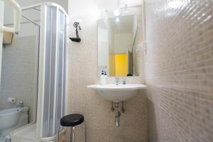 a bathroom with a sink and a toilet and a mirror at Quo Vadis Roma 2 in Rome