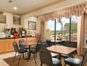 a room with tables and chairs and a kitchen at Days Inn by Wyndham Newton in Newton