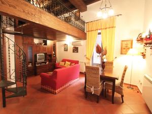 a living room with a red couch and a table at Orologio del Massimo in Palermo