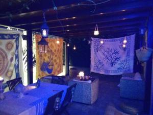 a dining room with blue tables and chairs and lights at Villetta Mistretta in Menfi