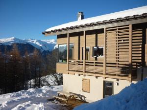 a house in the snow with a view of the mountains at Le Refuge de Montgésin in Aime-La Plagne