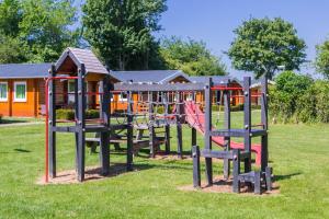 a row of playground equipment in a park at Camping "De Stuurmanskolk" in Welsum