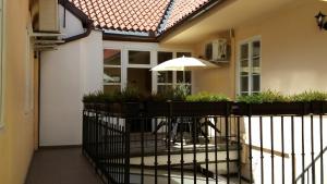 a balcony with a table and an umbrella at Apartments U Švejků in Prague