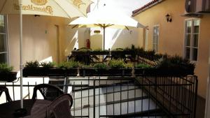 a patio with tables and chairs and an umbrella at Apartments U Švejků in Prague