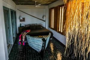 a room with a bed and a boat on the floor at Munga Guesthouse in Taghazout