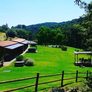 a large yard with a fence and green grass at Lebbiano Residence in Scandicci