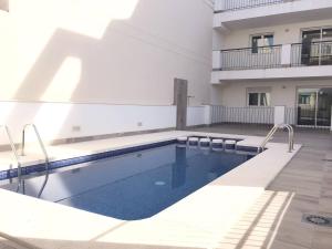 a swimming pool in front of a building at Apartment Santa Teresa in Altea