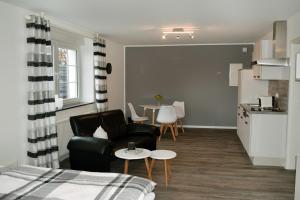 a living room with a couch and a table at Ferienwohnung Palmen in Gangelt