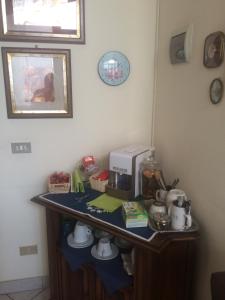 a table with a coffee maker on top of it at B&B Cittadella in Parma