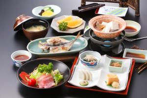
plates of food on a table at Hakone Yumoto Onsen Hotel Kajikaso in Hakone
