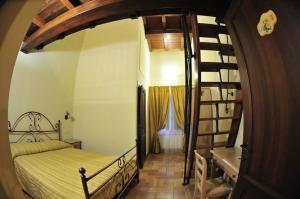 a bedroom with a bunk bed and a spiral staircase at Azienda Agrituristica La Valle del Sambuco in Norcia