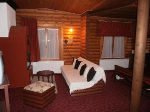 a bedroom with a bed in a log cabin at Stivakti Chalet in Áyios Nikólaos